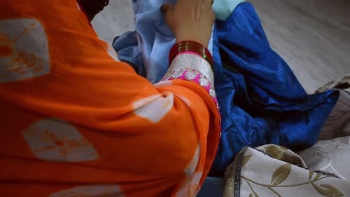 Adult Woman Hand-Sewing Fabrics Close Up