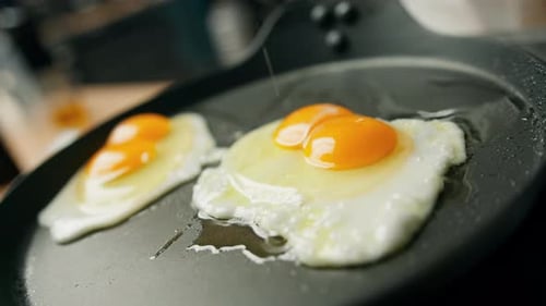 Eggs Cooking on a Frying Pan with Salt