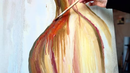 Beautiful woman painting with watercolors at an art gallery workshop