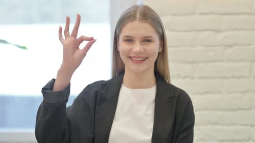 Young Adult Woman Giving Ok Hand Gesture