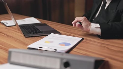Senior Businessman Reviewing Charts in Office