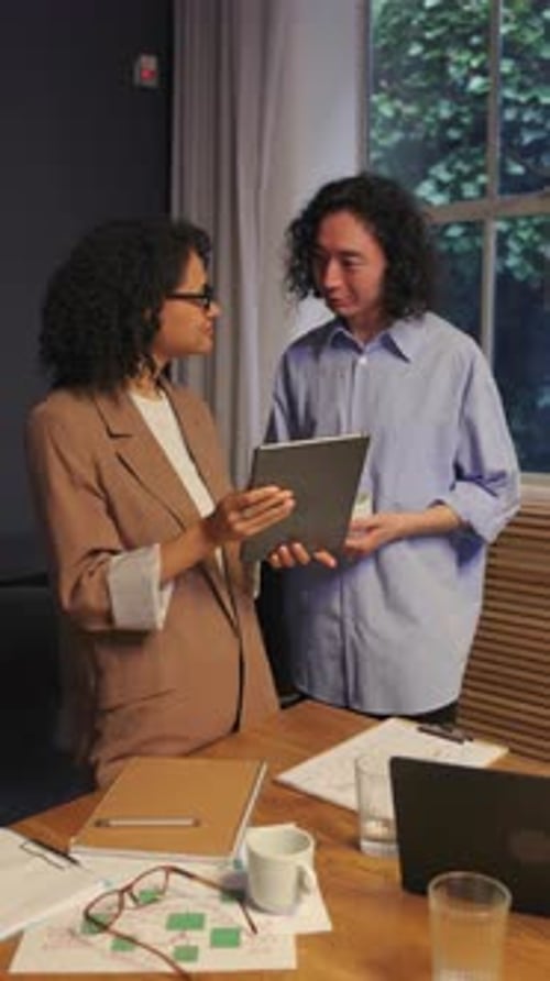 Diverse Business People Discussing Project and Using Digital Tablet in Office Room