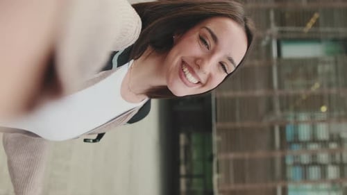 Smiling Woman Taking Selfie Outdoors in Urban Setting