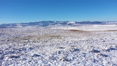 Aerial View of Snow Covered Hills and Mountain in the Winter