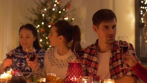 Friends Gather Around Table Celebrating Christmas