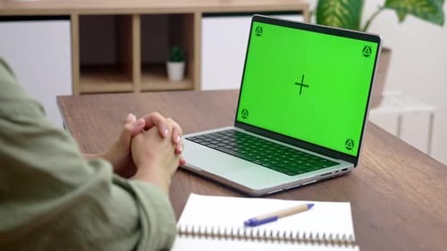 Woman at Desk With Green Screen Laptop