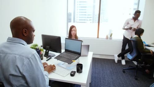 Business People Working and Video Conferencing in Open Plan Office 2529 Years