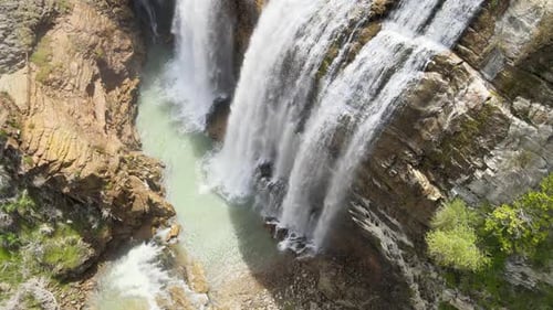 Majestic Waterfall Cascades Down Rocky Terrain