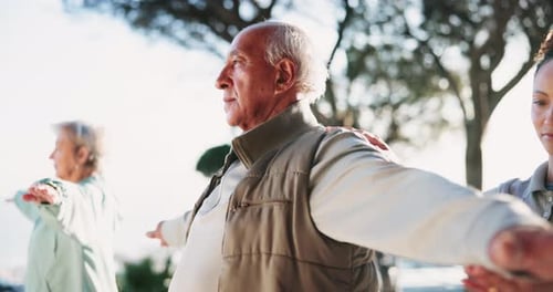 Seniors Exercising Outdoors with Adult Adjusting Arms