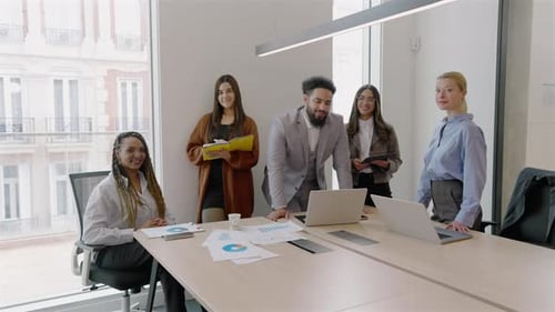 A Diverse Team Engages in Collaborative Efforts Within a Modern Office Environment