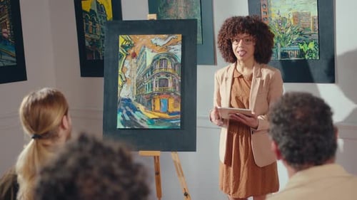 Art Auctioneer Presenting Colorful Building Painting