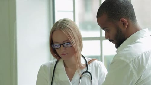 Doctor Explains Results to Patient Using Tablet