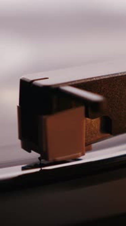 Close up of vinyl record player. Vintage spinning vinyl record. Vertical video