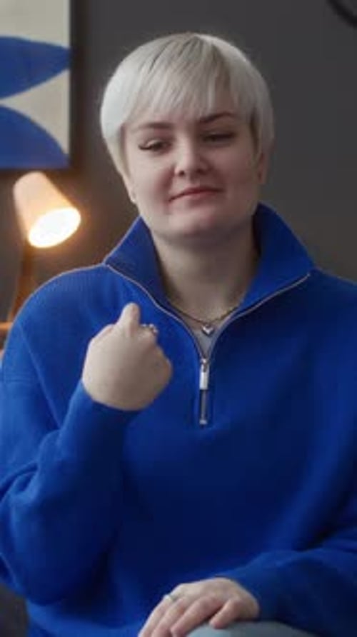 Young Woman Using Sign Language Indoors
