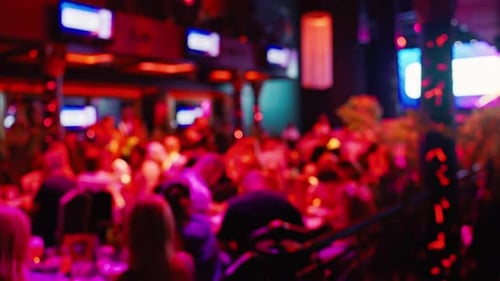 Blurred Crowded Nightlife Gathering with Bright Lights