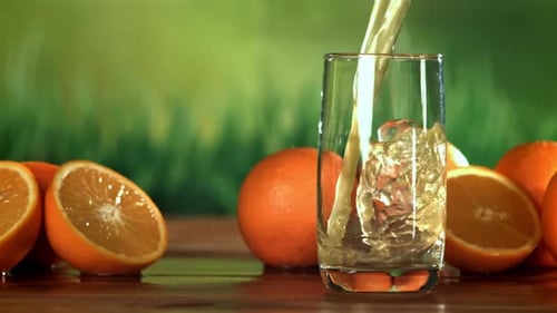 Pouring Fresh Orange Juice into a Glass