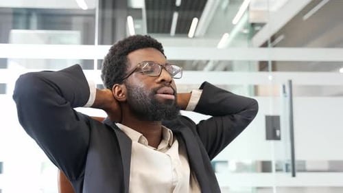Adult Relaxing in Office Chair Smiling
