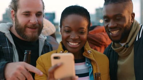 Friends Gather on Rooftop Viewing Phone Together