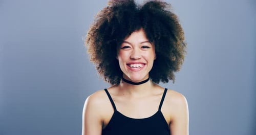 Smiling Woman with Large Curly Hair Laughing