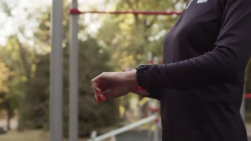 Woman Training with Smartwatch in the Park