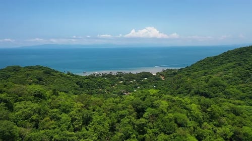 Aerial View of Tropical Coastline and Lush Green Hills