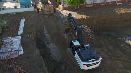 Excavator Digging Trench for Construction, Aerial View