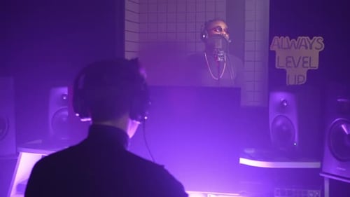 Sound Engineer and Man Singer Recording Music in Audio Studio