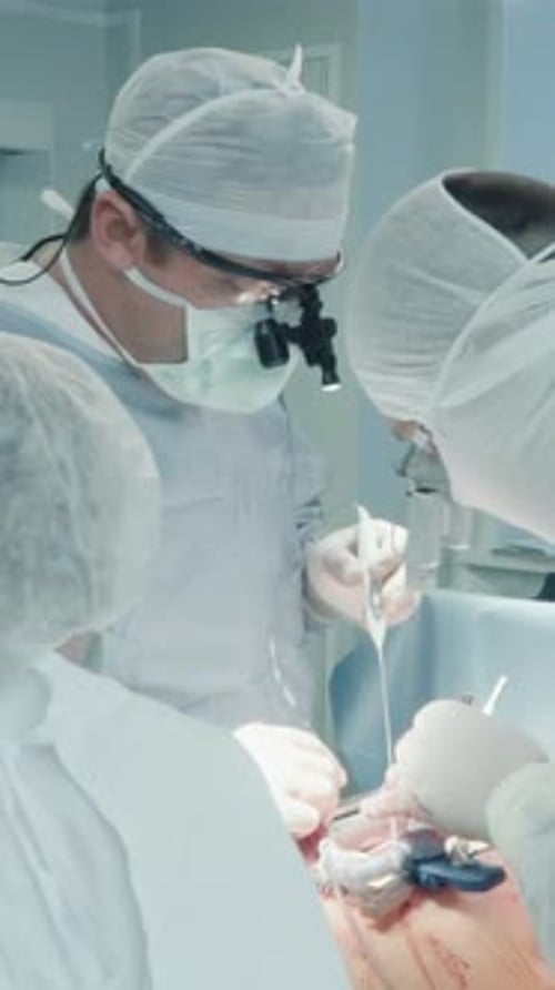 Doctors Performing Complex Surgery in Operating Room