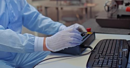 Person Working with Controls in Clean Environment
