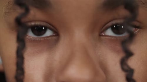 Portrait of a Dark Skinned Girl Teen Girl Looks Into the Camera Closeup View of Eyes Serious Look