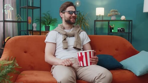 Man Wearing 3D Glasses Watching Movie on Couch