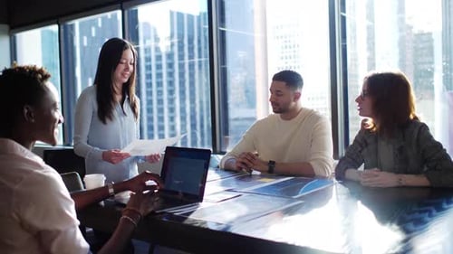 Creative Business People Discussing Proofs In Sunny Highrise Office Slow Motion
