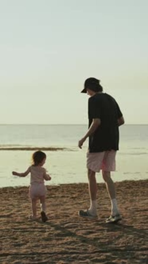 A Child Joyfully Playing on the Beach with an Adult in a Moment of Pure Happiness Vertical Video