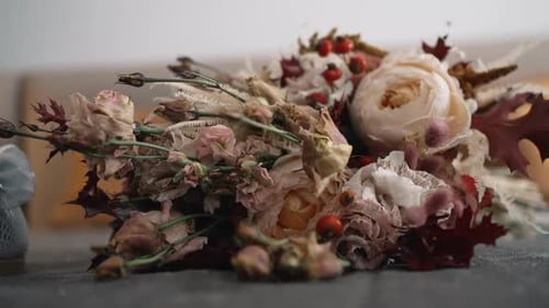 Dried floral arrangement on textured backdrop