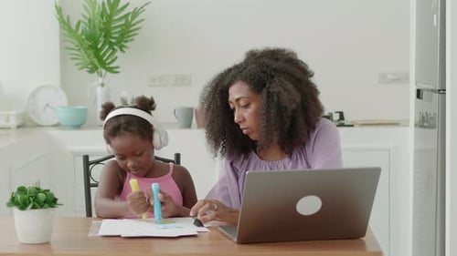 Mother and Child Working and Coloring at Home