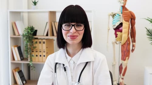 Confident Female Doctor at Office Desk Ready to Assist Patients