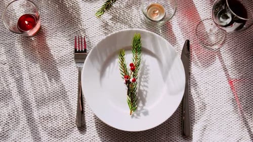 Elegant Christmas Place Setting with Candles and Wine