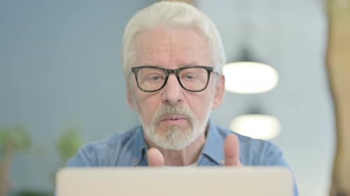 Close Up of Old Man Doing Video Chat on Laptop