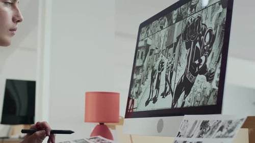 Female Digital Artist Drawing Comic Book at Desk