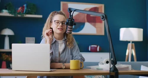 Woman Recording Podcast at Desk in Her Home