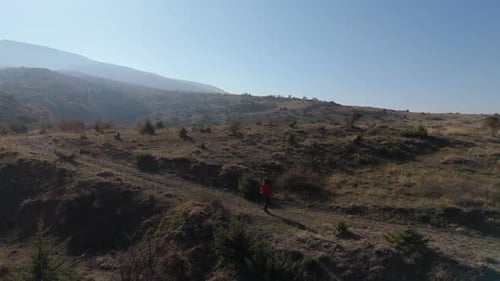 Aerial View Young hiker walking on a mountain path on a sunny day