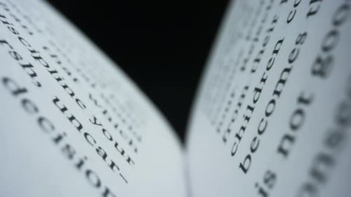 Macro View Open Book with White Pages Against Black Background. Dolly