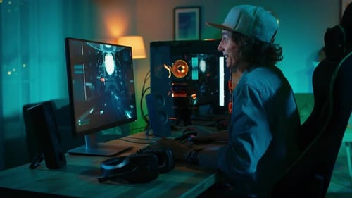 Young man enthusiastically playing video game at home