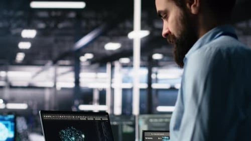 Data Center Programmer Using Laptop to Monitor Neural Network Using AI Chatbot