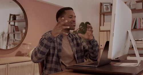 Male Working at home on Videocall using computer in Home Office