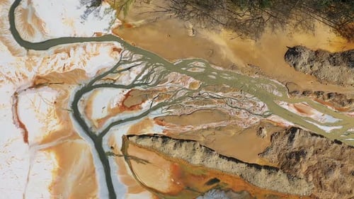 Aerial view of acidic mine residual water drainage, flowing into decanting pond