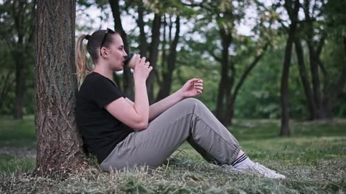 Woman Drinking Coffee in Nature