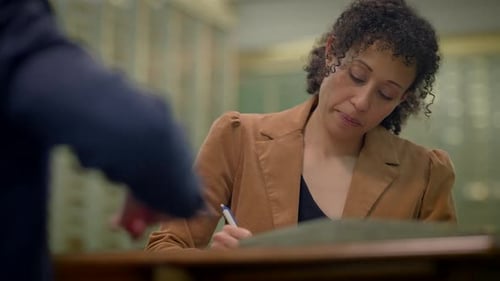Woman Signs Business Deal with Man