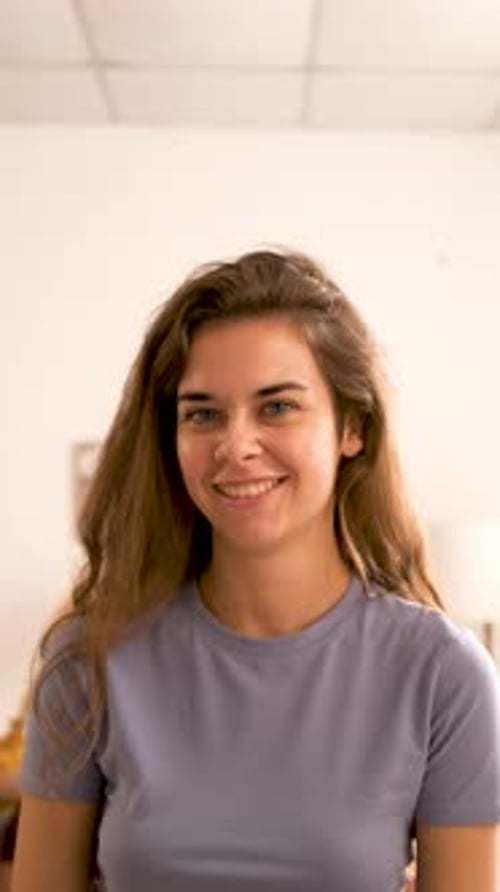 Woman Smiling Confidently at Camera in Home