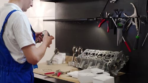 Professional Mechanic Assembles Engine with Precision Tools Installs Pistons Rings Liners in